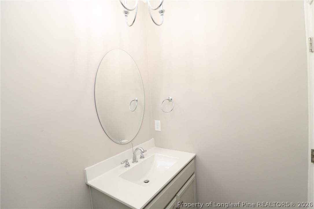 2824 Plumfield Place Raleigh, NC 27607 - Photo 18 of 33 a bathroom with a sink a mirror and vanity