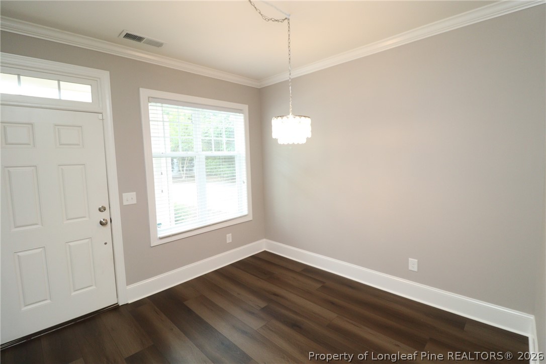 2824 Plumfield Place Raleigh, NC 27607 - Photo 2 of 33 a view of an empty room with wooden floor and a window