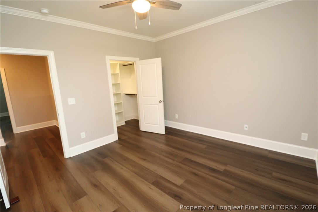 2824 Plumfield Place Raleigh, NC 27607 - Photo 22 of 33 a view of an empty room with wooden floor and a ceiling fan