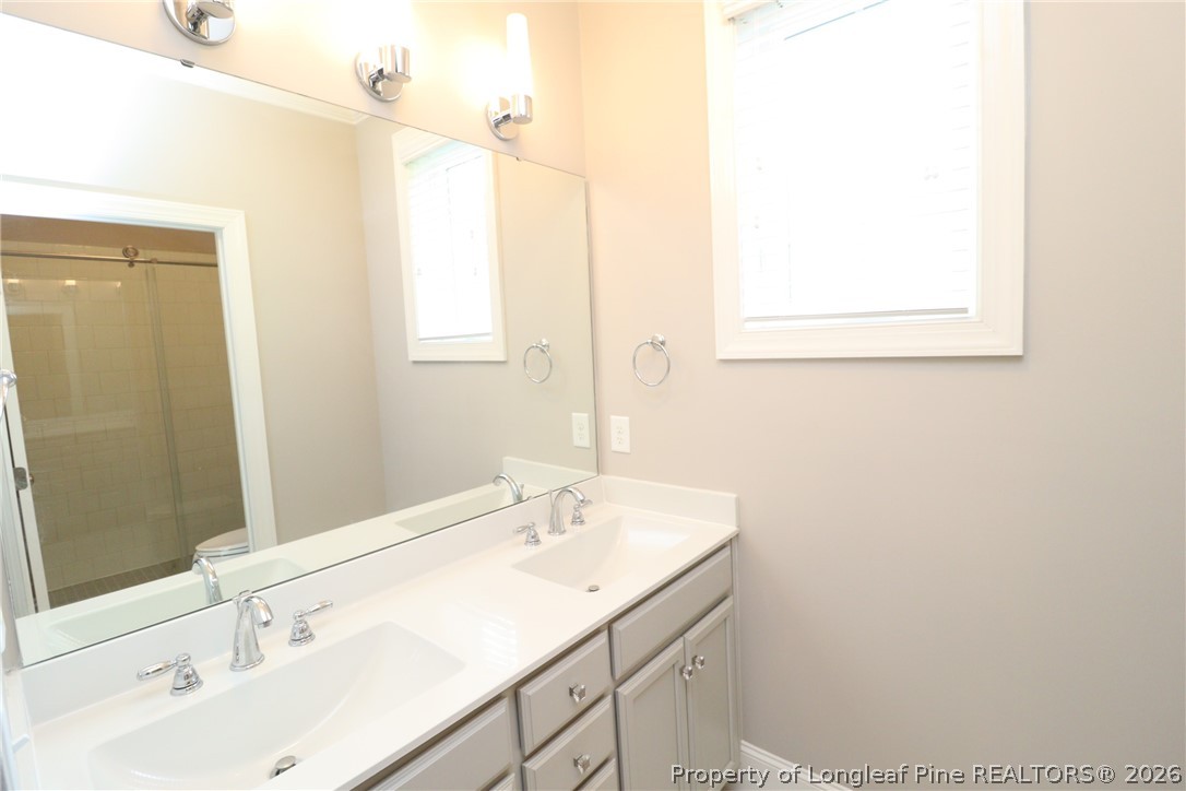 2824 Plumfield Place Raleigh, NC 27607 - Photo 25 of 33 a bathroom with a sink and a mirror