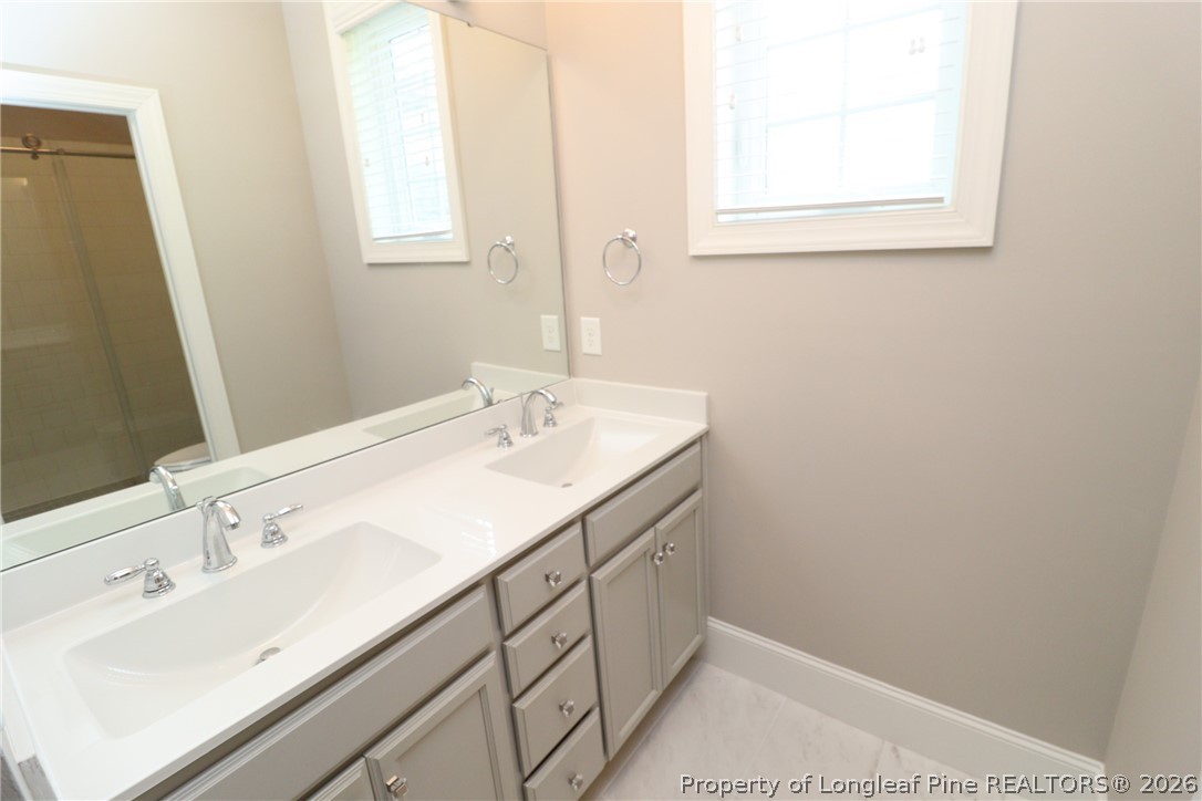 2824 Plumfield Place Raleigh, NC 27607 - Photo 26 of 33 a bathroom with a sink and a window