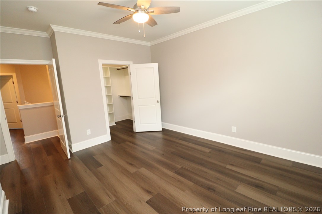2824 Plumfield Place Raleigh, NC 27607 - Photo 30 of 33 an empty room with wooden floor and ceiling fan