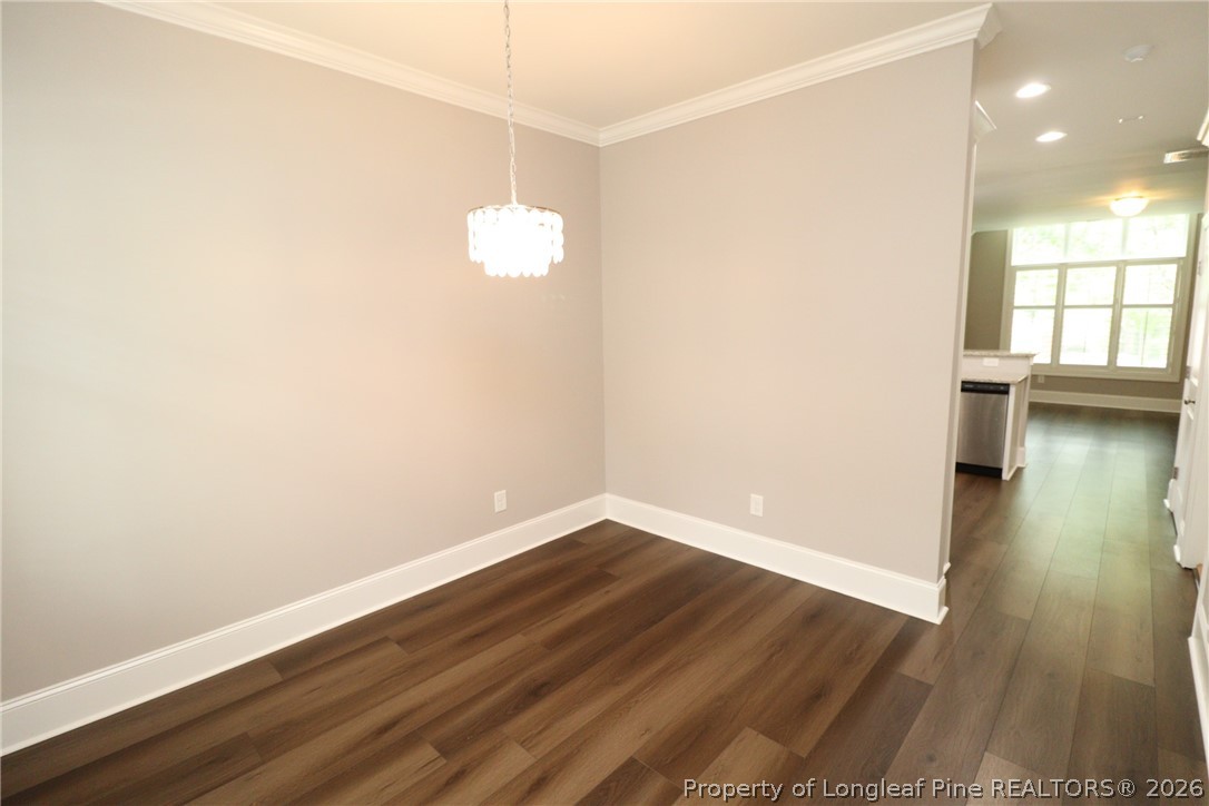 2824 Plumfield Place Raleigh, NC 27607 - Photo 3 of 33 a view of empty room with wooden floor and fan