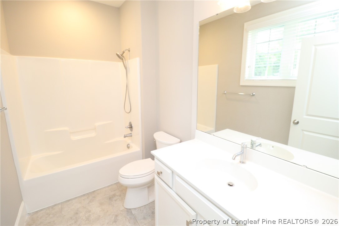 2824 Plumfield Place Raleigh, NC 27607 - Photo 32 of 33 a bathroom with a sink a toilet and shower