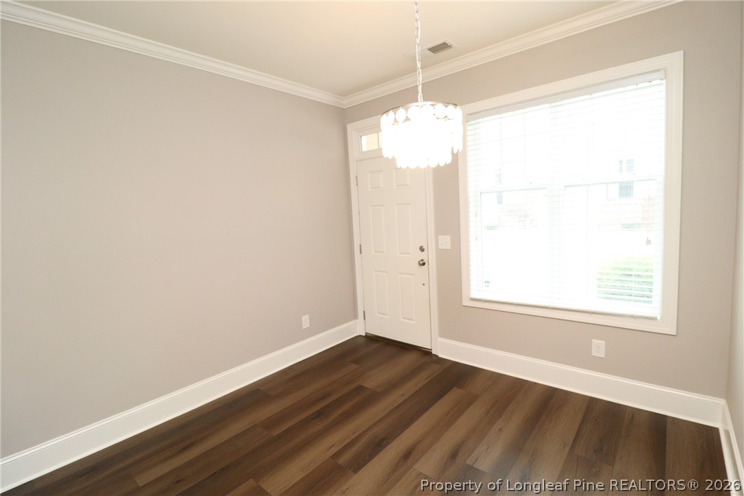 2824 Plumfield Place Raleigh, NC 27607 - Photo 5 of 33 an empty room with wooden floor and windows