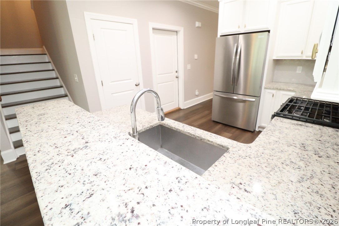 2824 Plumfield Place Raleigh, NC 27607 - Photo 8 of 33 a kitchen with a refrigerator and a stove top oven