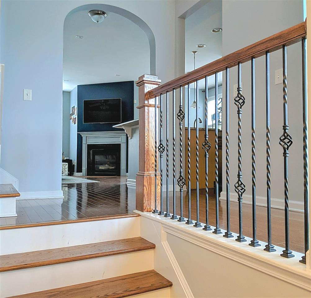 9244 Wooden Road Raleigh, NC 27617 - Photo 6 of 20 Beautiful hardwood staircase with iron railing and archways invite you into the open family, kitchen & breakfast area.