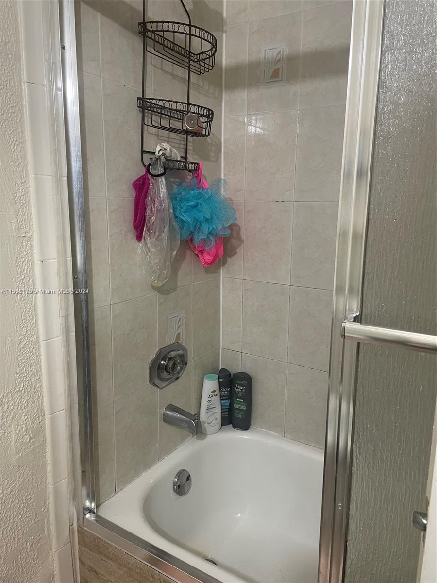 3252 Foxcroft Road, Unit 208 Miramar, FL 33025 - Photo 11 of 13 a bathroom with a shower