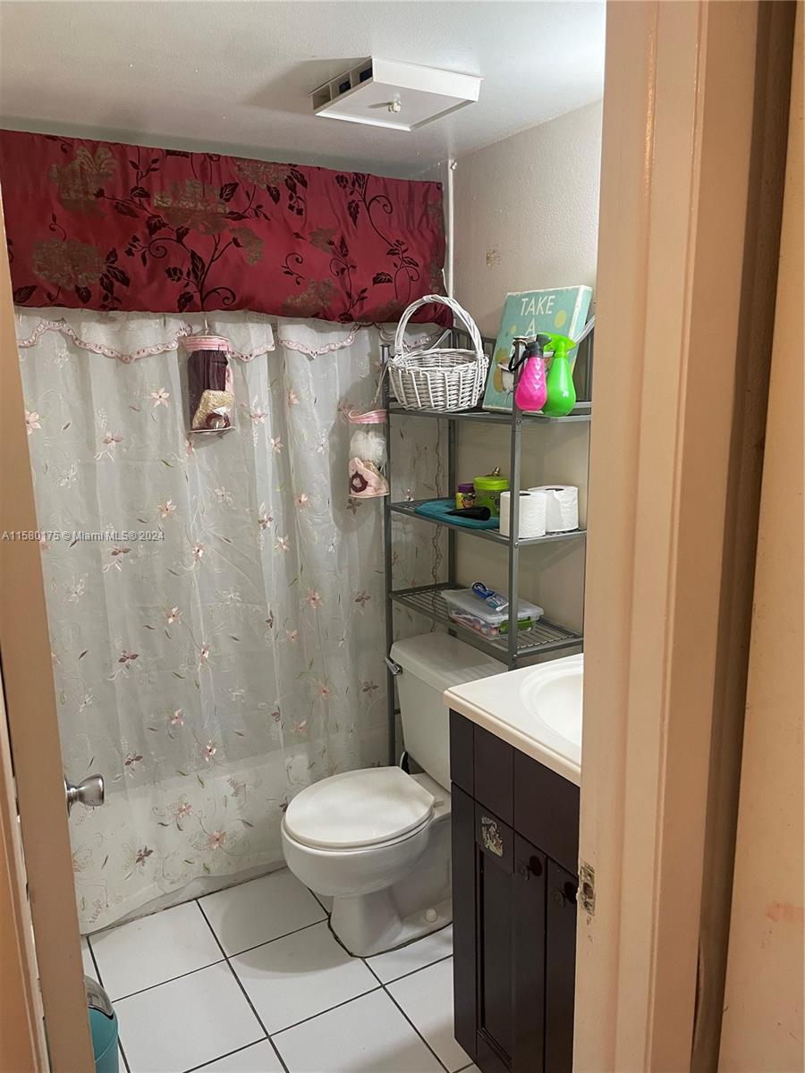 3252 Foxcroft Road, Unit 208 Miramar, FL 33025 - Photo 6 of 13 a bathroom with a sink a toilet and shower