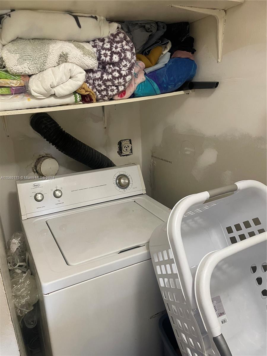 3252 Foxcroft Road, Unit 208 Miramar, FL 33025 - Photo 7 of 13 a utility room with dryer and washer