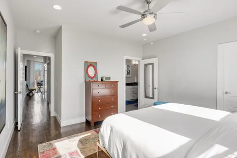 a bedroom with a bed and a chandelier