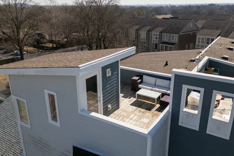 a view of balcony with wooden floor and outdoor seating