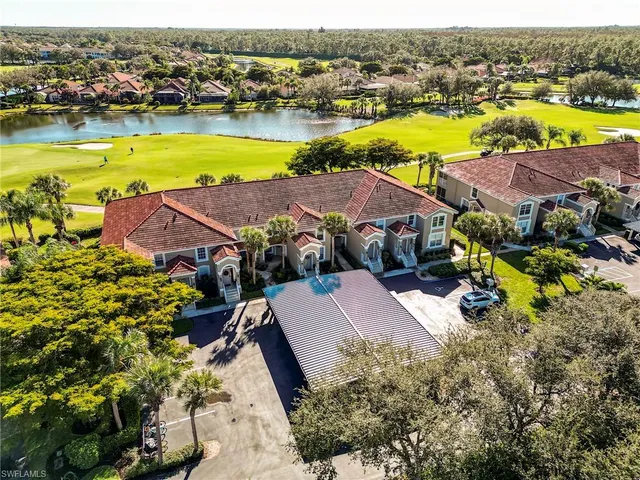 an aerial view of residential houses with outdoor space and ocean view