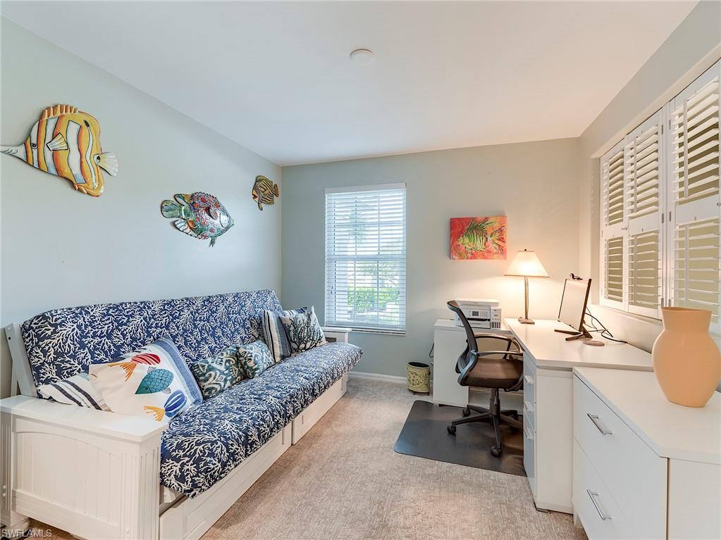 9010 Spring Run Boulevard, Unit 702 Estero, FL 34135 - Photo 12 of 35 a living room with furniture and a window