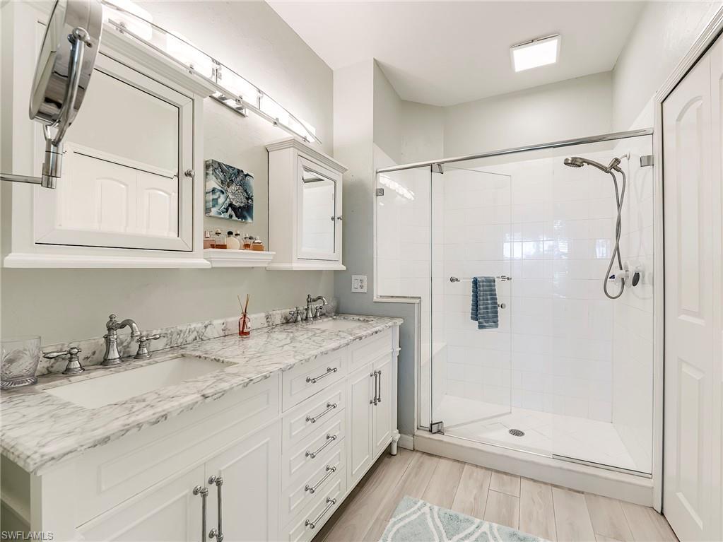 9010 Spring Run Boulevard, Unit 702 Estero, FL 34135 - Photo 16 of 35 a bathroom with a granite countertop sink mirror and double