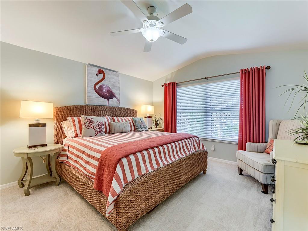 9010 Spring Run Boulevard, Unit 702 Estero, FL 34135 - Photo 17 of 35 a bed room with a bed and a chandelier