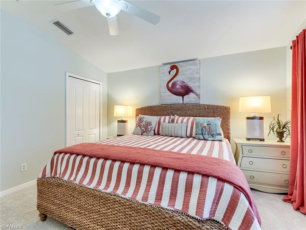 9010 Spring Run Boulevard, Unit 702 Estero, FL 34135 - Photo 18 of 35 a bedroom with a bed and a chandelier