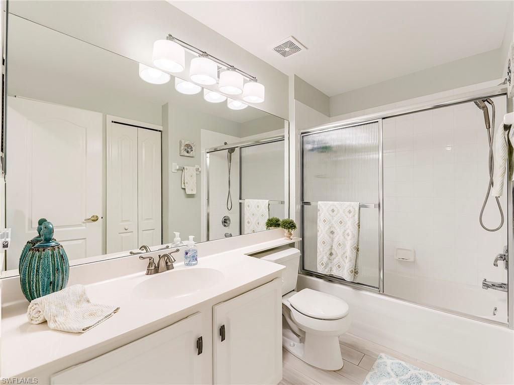 9010 Spring Run Boulevard, Unit 702 Estero, FL 34135 - Photo 19 of 35 a bathroom with a sink a toilet and shower