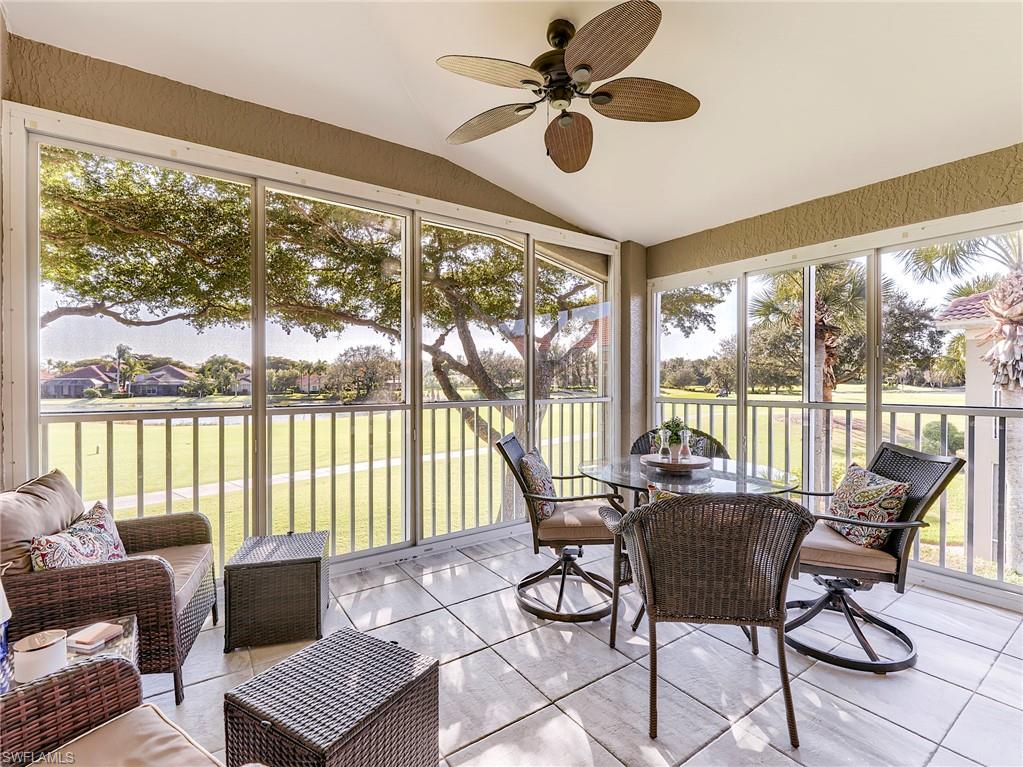 9010 Spring Run Boulevard, Unit 702 Estero, FL 34135 - Photo 2 of 35 a living room with furniture and a floor to ceiling window