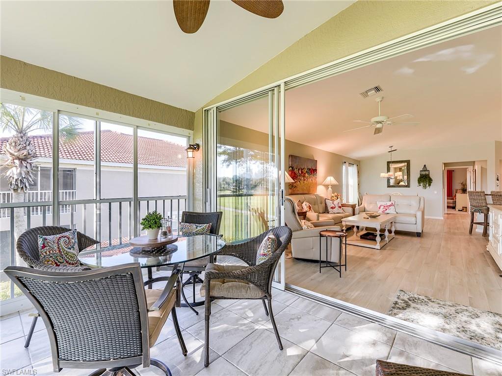 9010 Spring Run Boulevard, Unit 702 Estero, FL 34135 - Photo 21 of 35 a living room with furniture and a large window