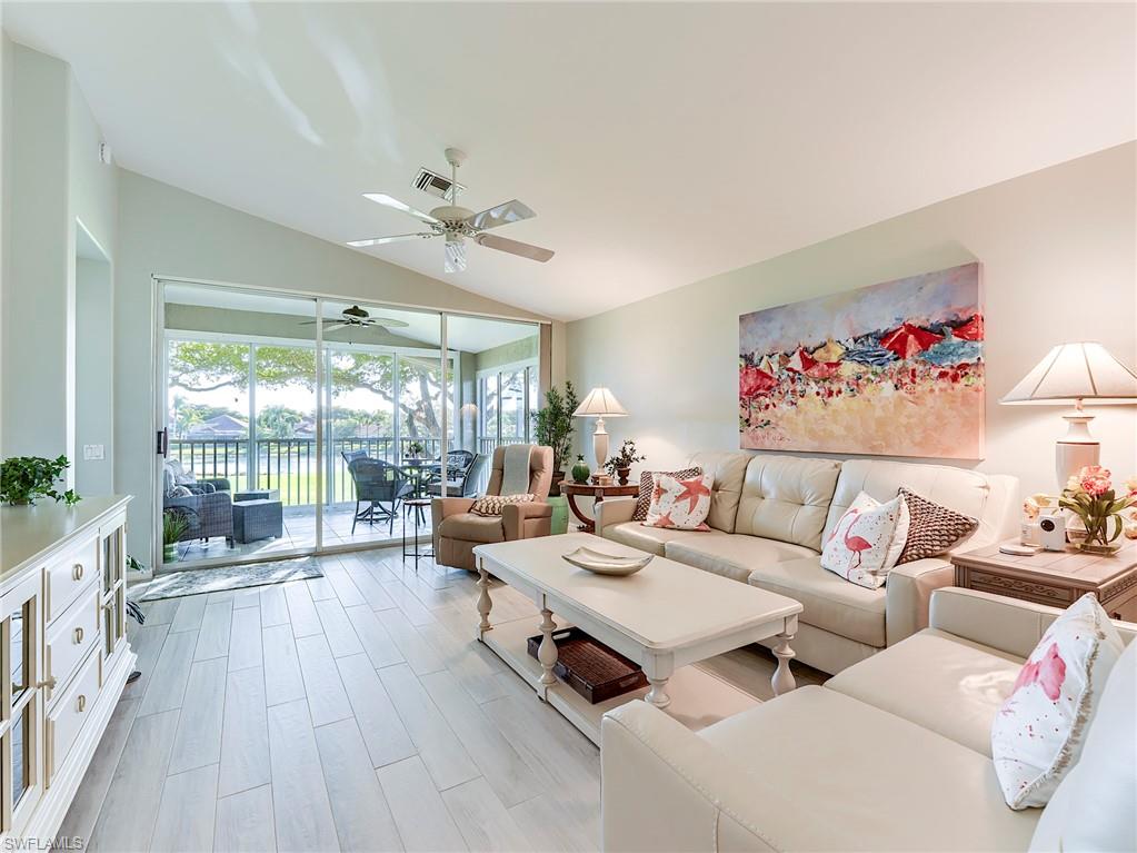 9010 Spring Run Boulevard, Unit 702 Estero, FL 34135 - Photo 5 of 35 a living room with furniture and a large window