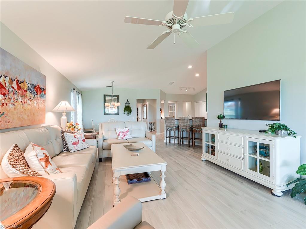 9010 Spring Run Boulevard, Unit 702 Estero, FL 34135 - Photo 6 of 35 a living room with furniture and a flat screen tv
