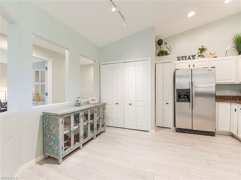 9010 Spring Run Boulevard, Unit 702 Estero, FL 34135 - Photo 9 of 35 a kitchen with stainless steel appliances a white and white cabinets