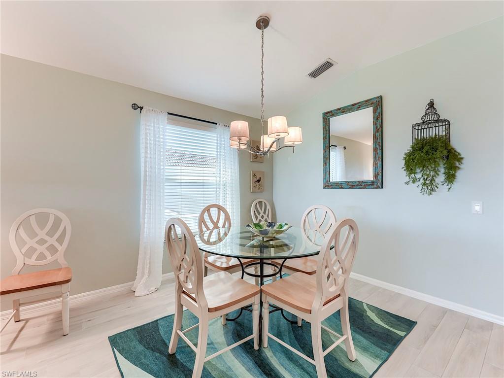 9010 Spring Run Boulevard, Unit 702 Estero, FL 34135 - Photo 10 of 35 a dining room with furniture and window