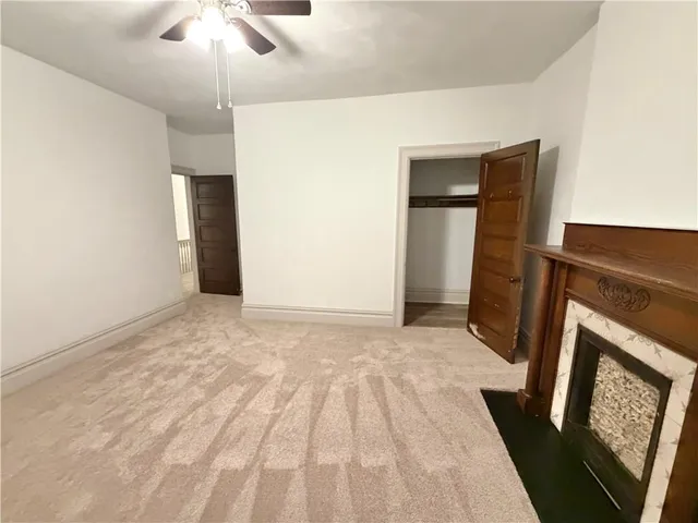 a view of a livingroom with a ceiling fan and hardwood floor