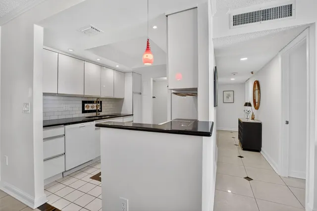 a kitchen with granite countertop cabinets stainless steel appliances and a sink
