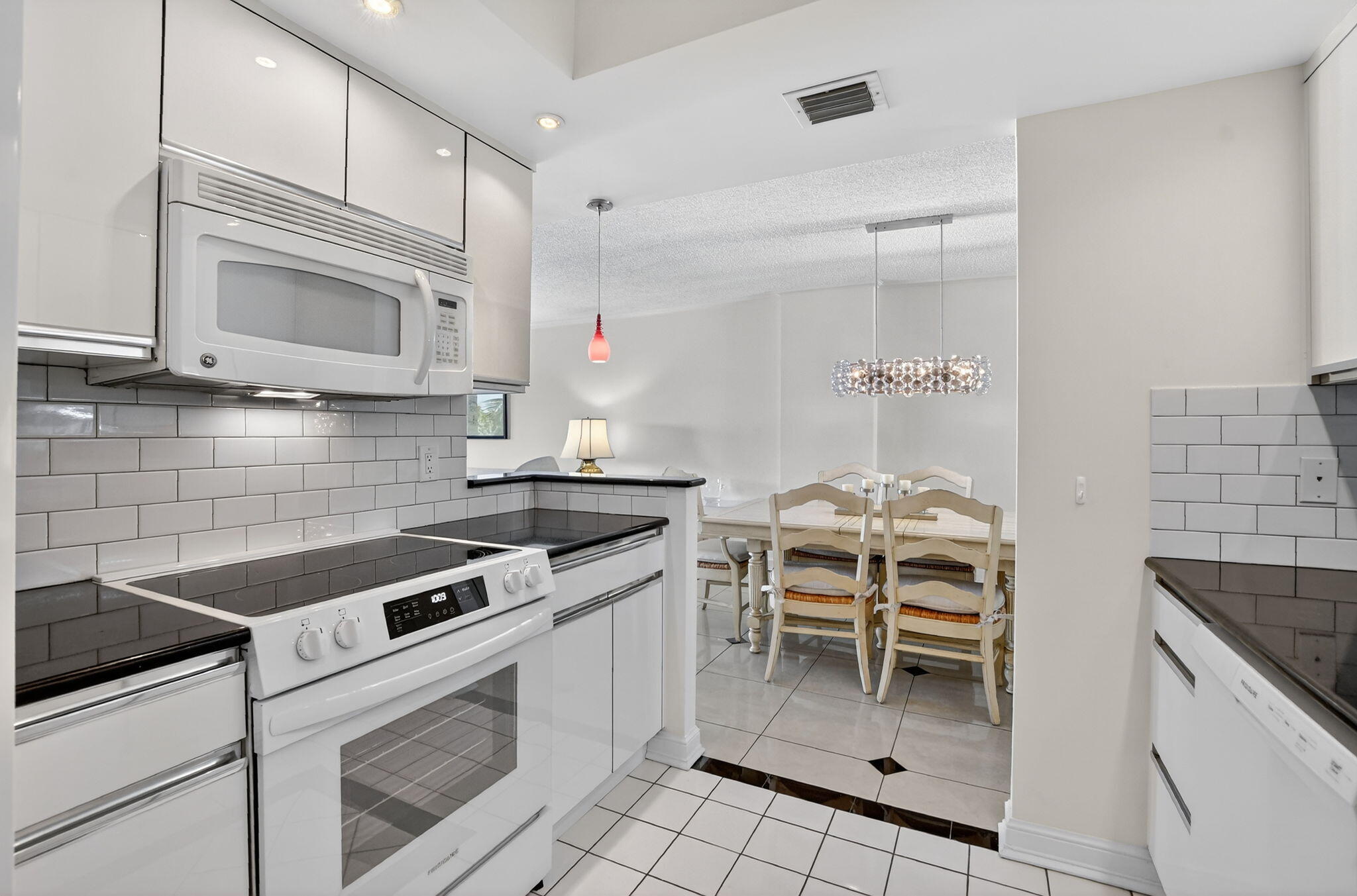 951 De Soto Road, Unit 427 Boca Raton, FL 33432 - Photo 18 of 50 a kitchen with a stove and a microwave