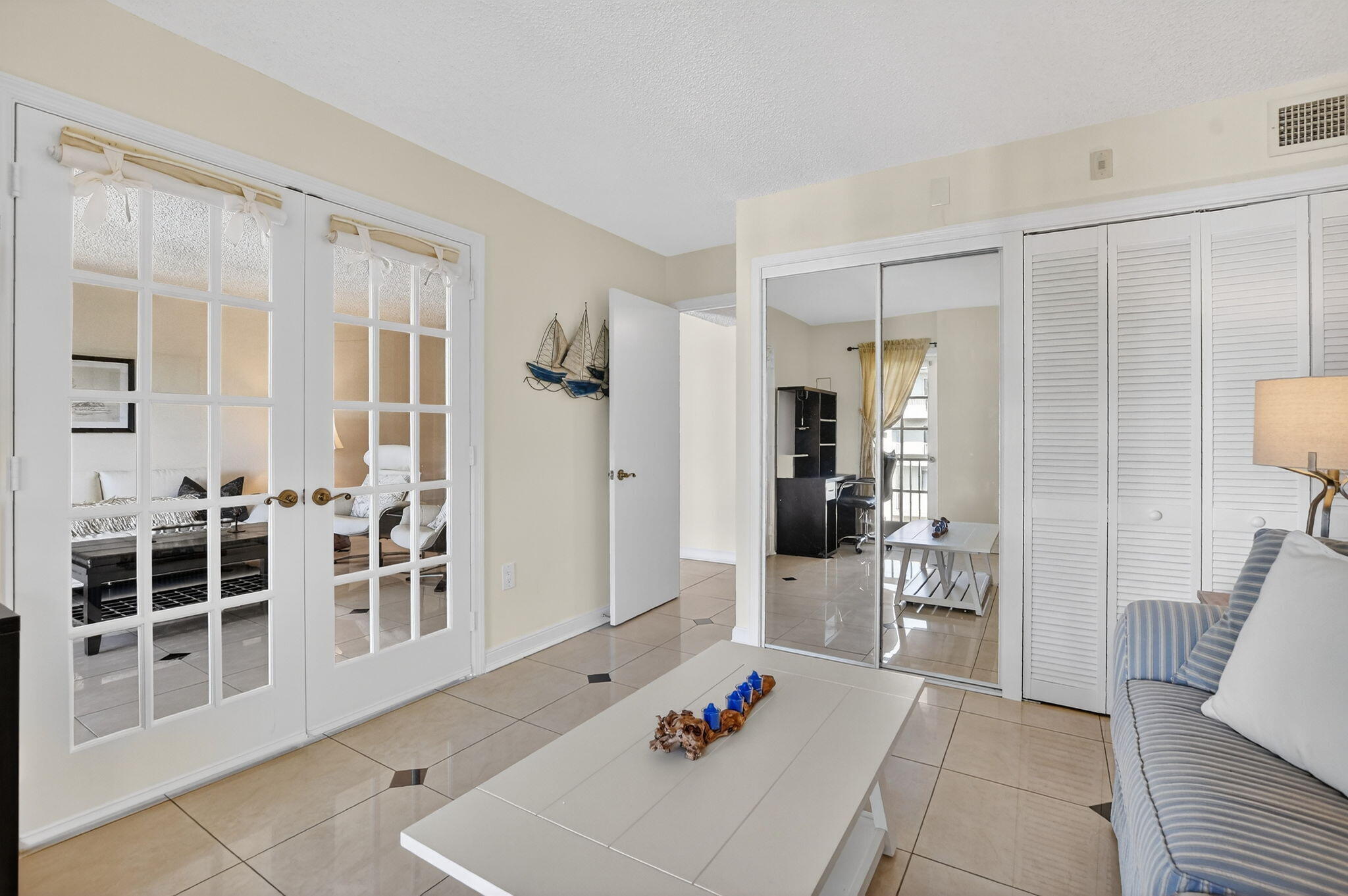 951 De Soto Road, Unit 427 Boca Raton, FL 33432 - Photo 22 of 50 a living room with furniture a flat screen tv and a table