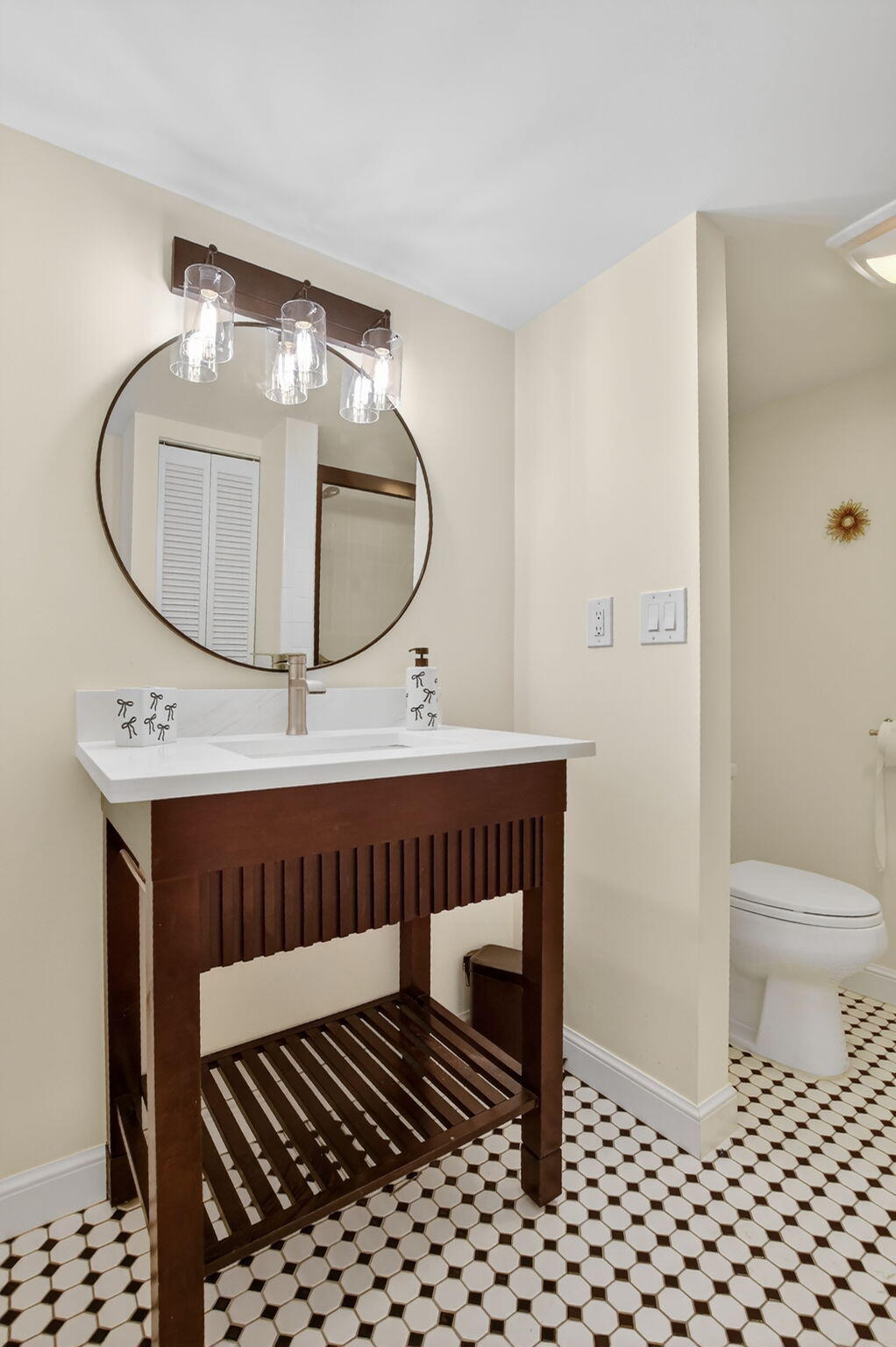 951 De Soto Road, Unit 427 Boca Raton, FL 33432 - Photo 28 of 50 a bathroom with a sink a toilet and a mirror