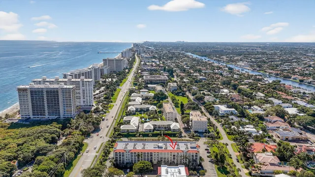 a view of a chairs and table under an umbrella in backyard