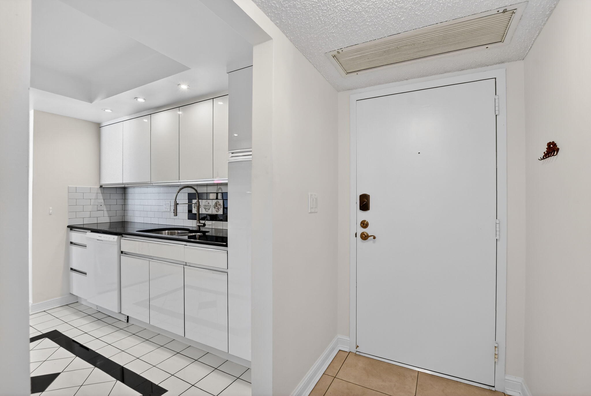 951 De Soto Road, Unit 427 Boca Raton, FL 33432 - Photo 6 of 50 a kitchen with stainless steel appliances a stove a refrigerator and cabinets