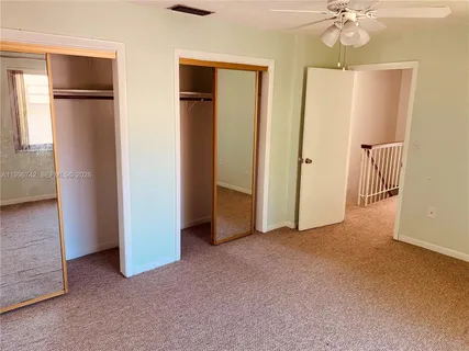 a view of empty room with a ceiling fan