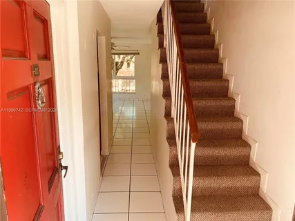 a view of staircase with white walls