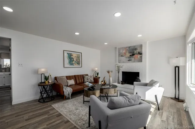 a living room with furniture a fireplace and a table