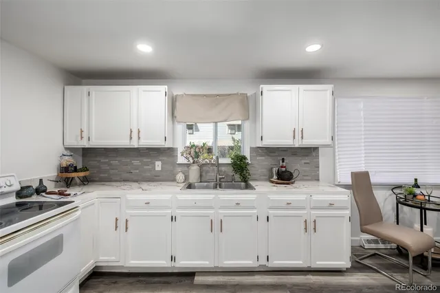 a kitchen with white cabinets and white appliances