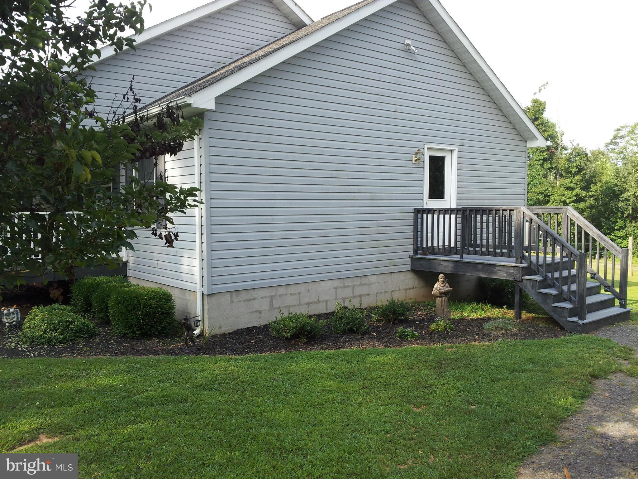 803 Turkey Ridge Road Castleton, VA 22716 - Photo 2 of 14 a view of a chair and table in the backyard