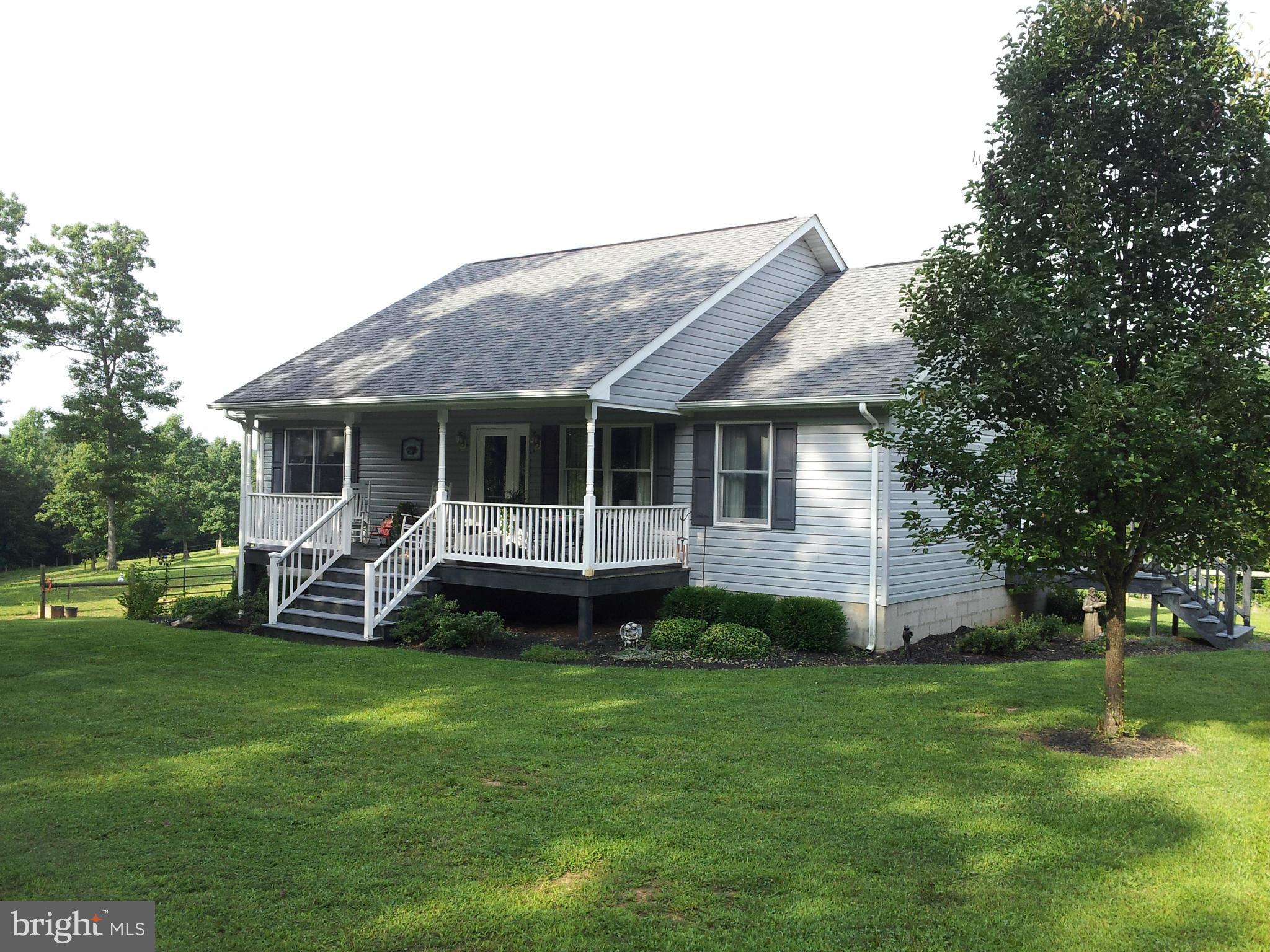 803 Turkey Ridge Road Castleton, VA 22716 - Photo 13 of 14 a front view of a house with a garden and trees