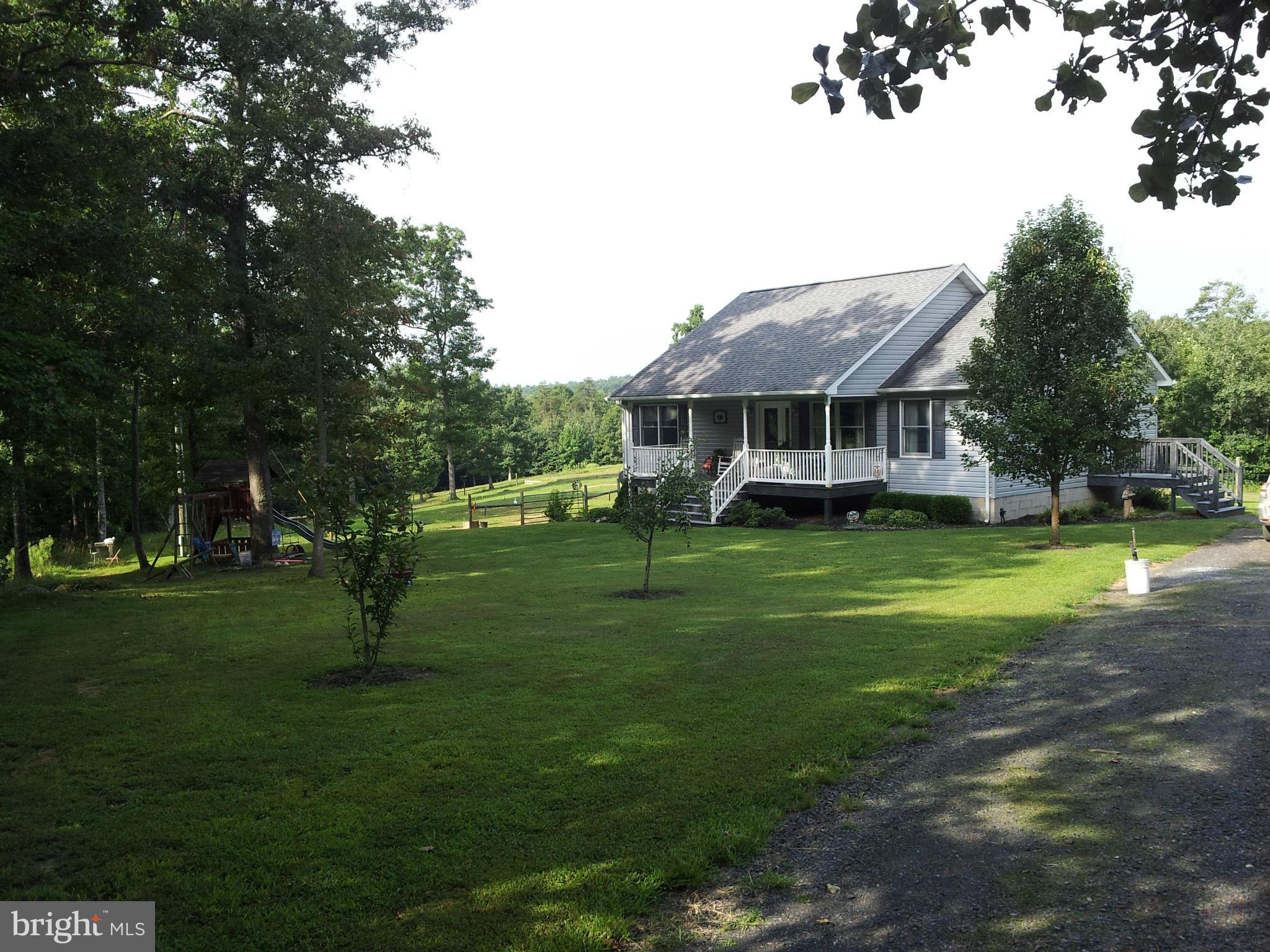 803 Turkey Ridge Road Castleton, VA 22716 - Photo 14 of 14 a front view of a house with a yard table and trees
