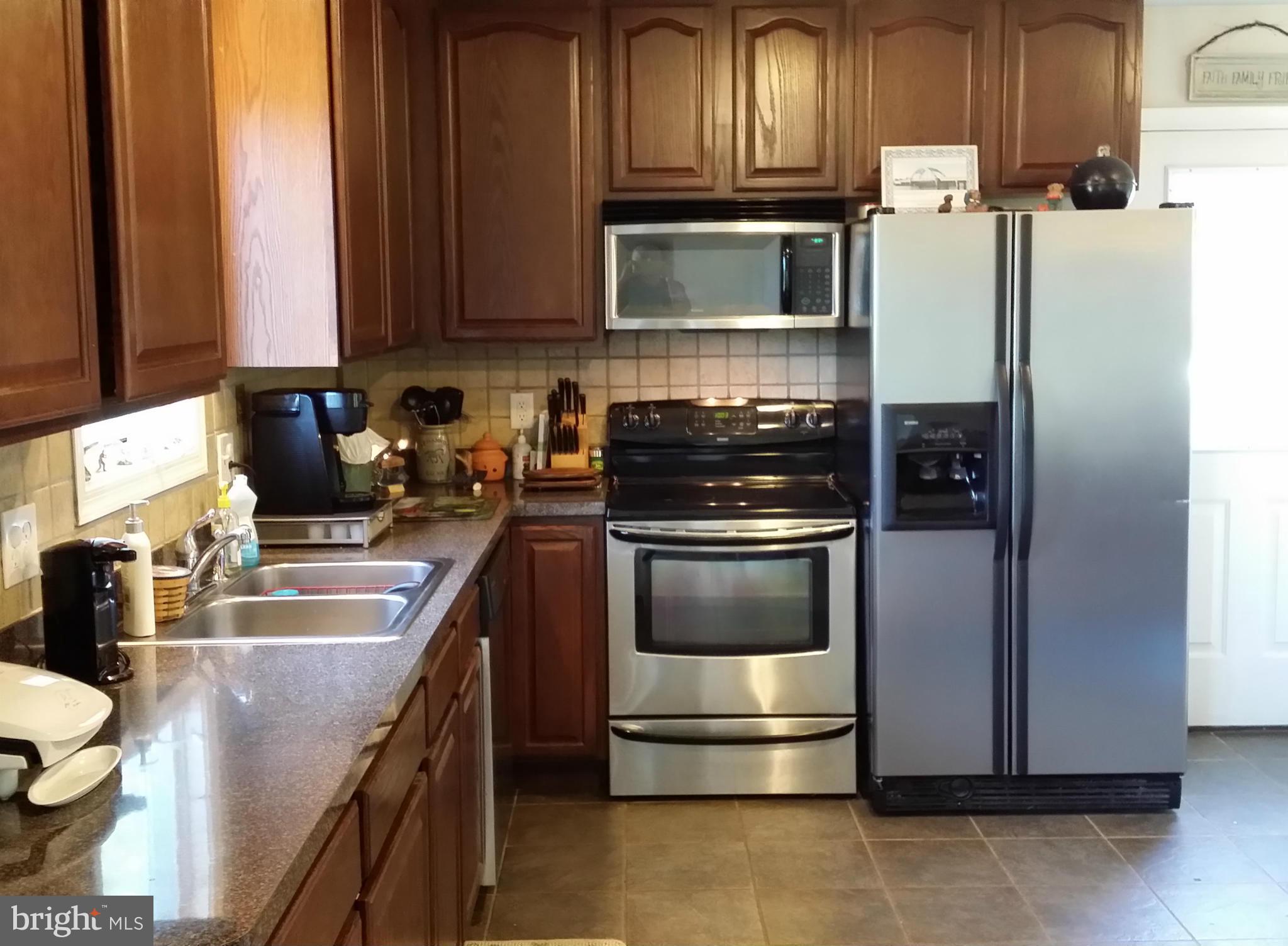 803 Turkey Ridge Road Castleton, VA 22716 - Photo 4 of 14 a kitchen with stainless steel appliances granite countertop a refrigerator stove and sink