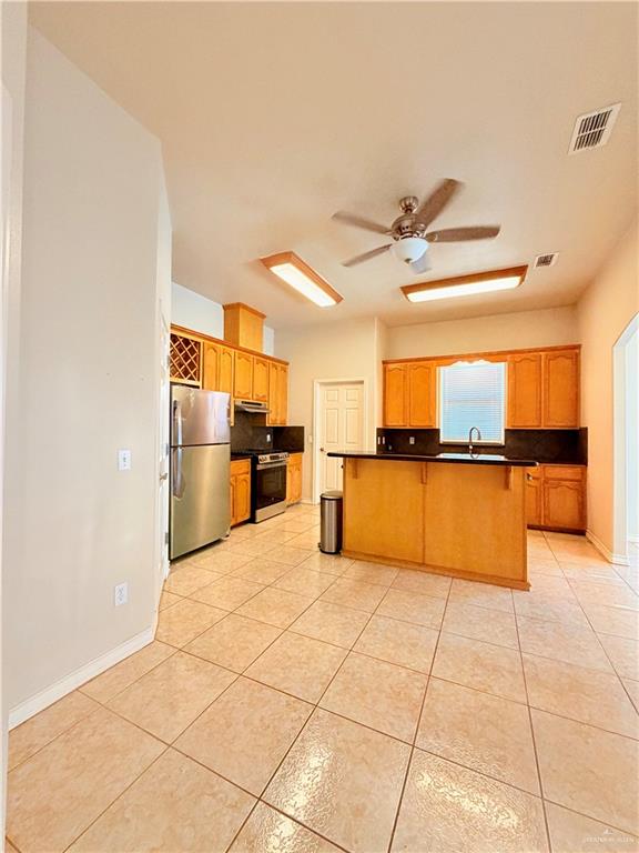 20724 North Fm 493 Road Edcouch, TX 78538 - Photo 4 of 20 a kitchen with granite countertop a refrigerator and a sink