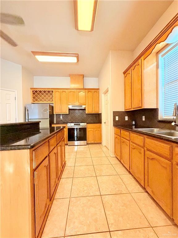 20724 North Fm 493 Road Edcouch, TX 78538 - Photo 5 of 20 a large kitchen with stainless steel appliances granite countertop a sink and cabinets