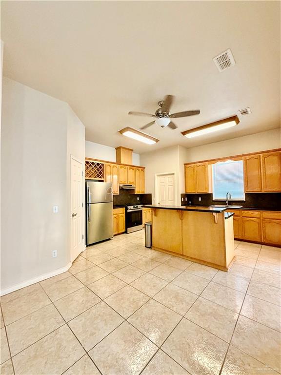 20724 North Fm 493 Road Edcouch, TX 78538 - Photo 6 of 20 a kitchen with stainless steel appliances kitchen island granite countertop a refrigerator and a sink