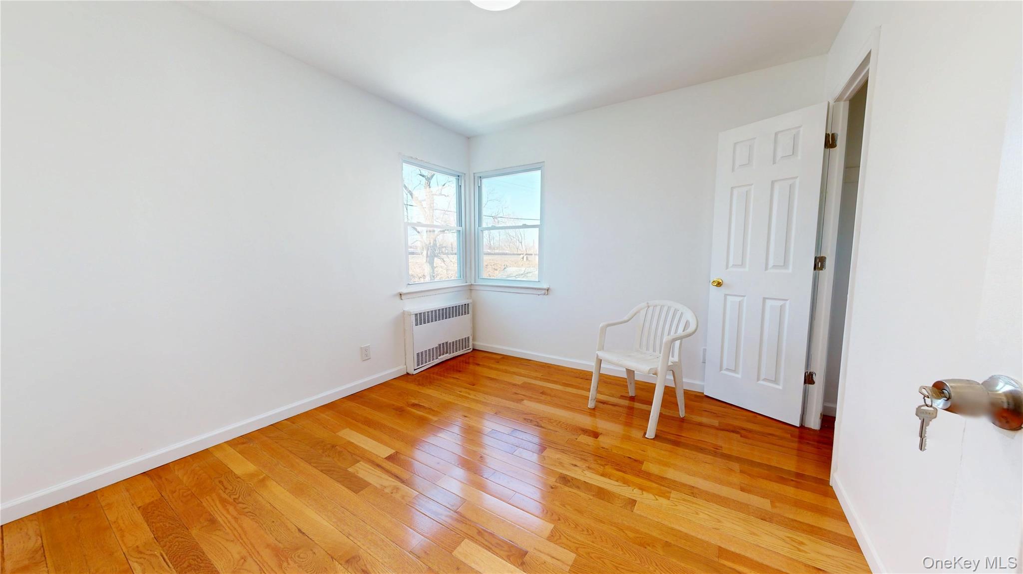 219-42 141st Road Queens, NY 11413 - Photo 17 of 23 a view of a room with wooden floor and chair