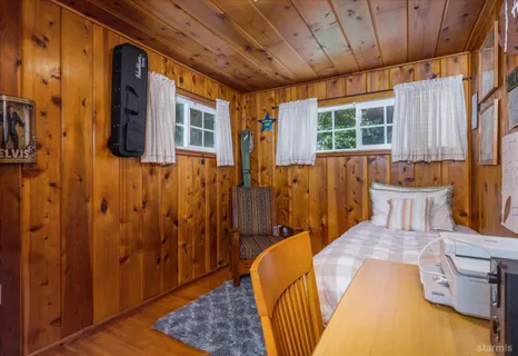 a bed room with a bed and wooden floor