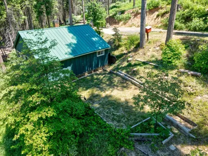 a view of a house with a tree in the yard