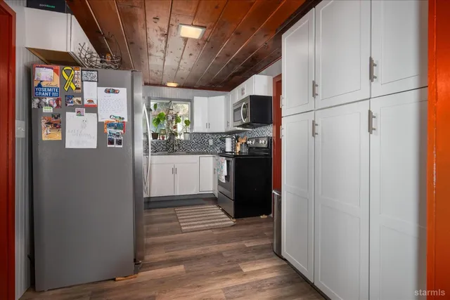 a kitchen with stainless steel appliances granite countertop a refrigerator and a stove